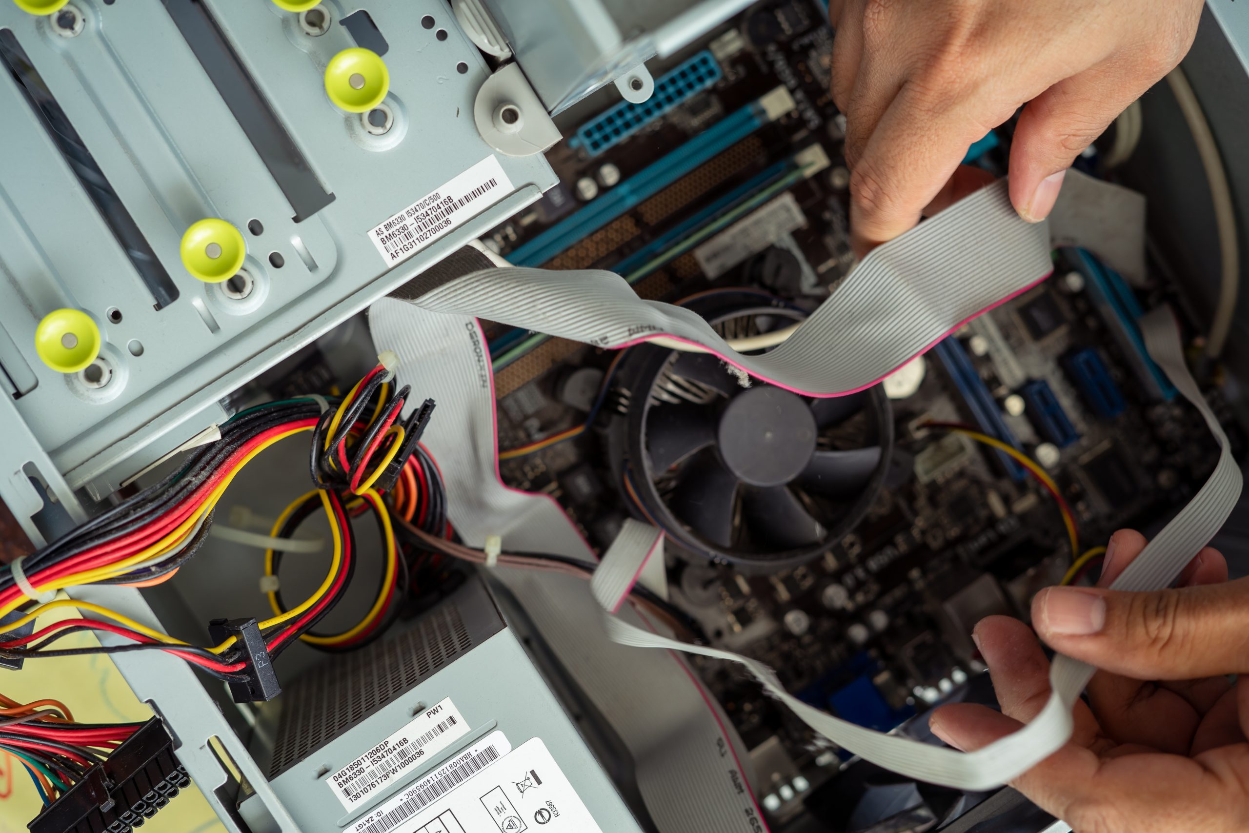 Kuala Lumpur, Malaysia - May 22, 2020:  Cleaning and fixing the personal computer (PC) with a vacuum cleaner. Computer service and maintainance.